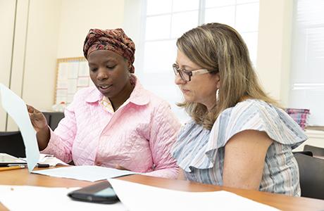 Woman being helped by a tutor